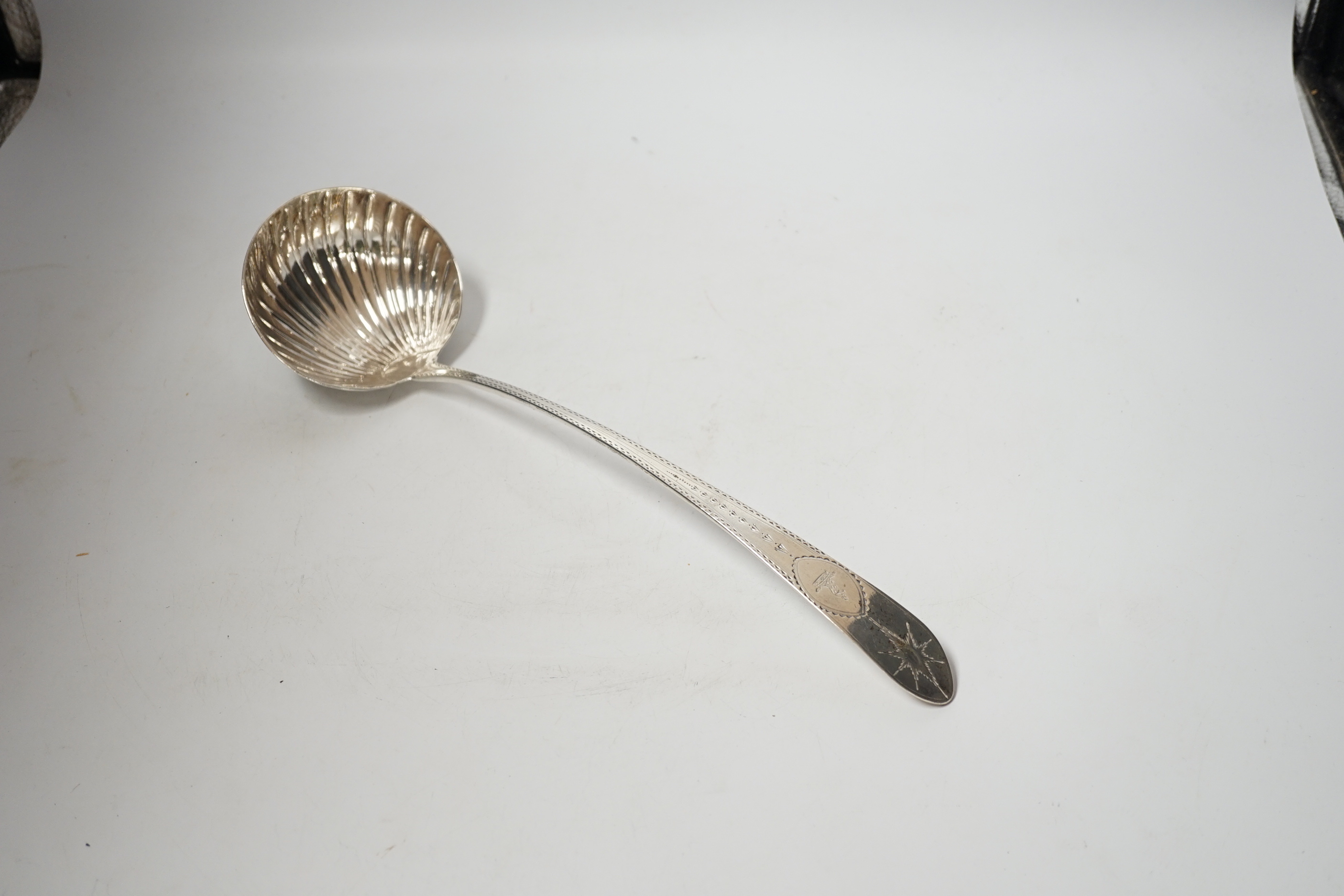 A George III Irish engraved silver soup ladle, John Shiels?, Dublin, 1793, 36cm, with fluted bowl